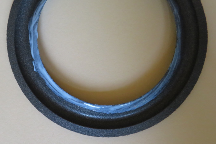 Glue on the inner lip of a foam surround
