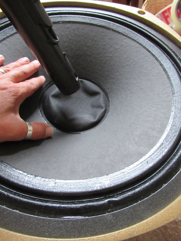 The suction of a vacuum cleaner is able to get a dented dust cap back into shape